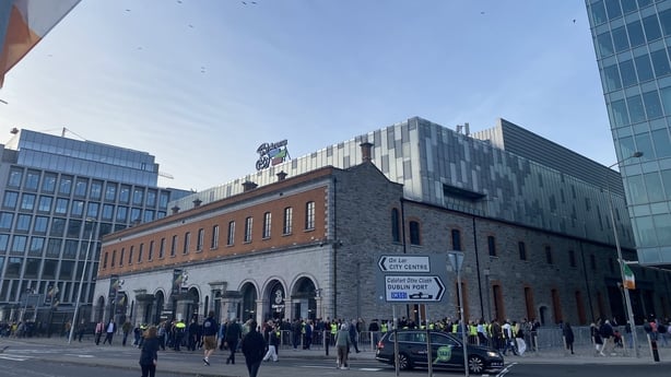 The outside of a building with people passing by