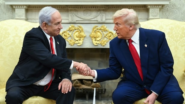 Two men shake hands