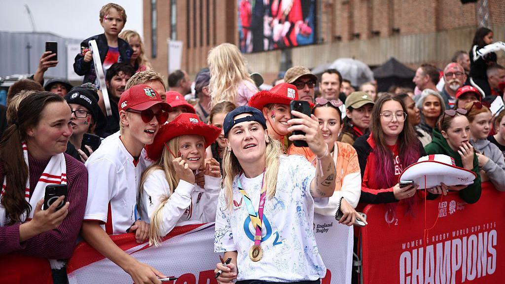 Megan Jones takes a selfie with fans