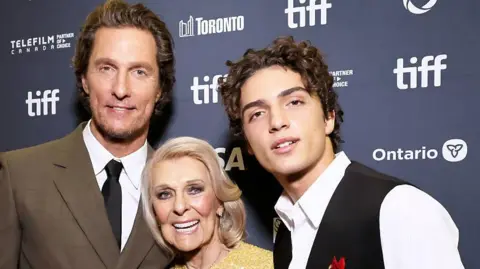 Getty Images Matthew, Kay and Levi McConaughey in smart clothes on the red carpet for the film at Toronto Film Festival