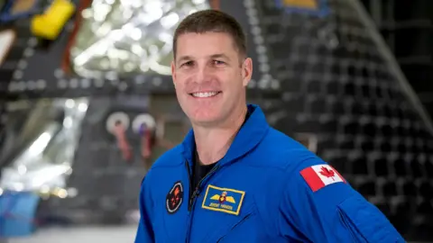 NASA Artemis II mission specialist Jeremy Hansen poses inside the Neil Armstrong Operations and Checkout Building at NASA’s Kennedy Space Center in Florida on Aug. 8, 2023. The Artemis II Orion crew module is undergoing acoustic testing ahead of integration with the European Service Module. Artemis II is the first crewed mission on NASA’s path to establishing a long-term lunar presence for science and exploration under Artemis.