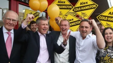 PA Media Menzies Campbell with Lib Dem colleagues Willie Rennie, Tim Farron and Alex Cole-Hamilton.  They are campaigning with balloons and Lib Dem posters.