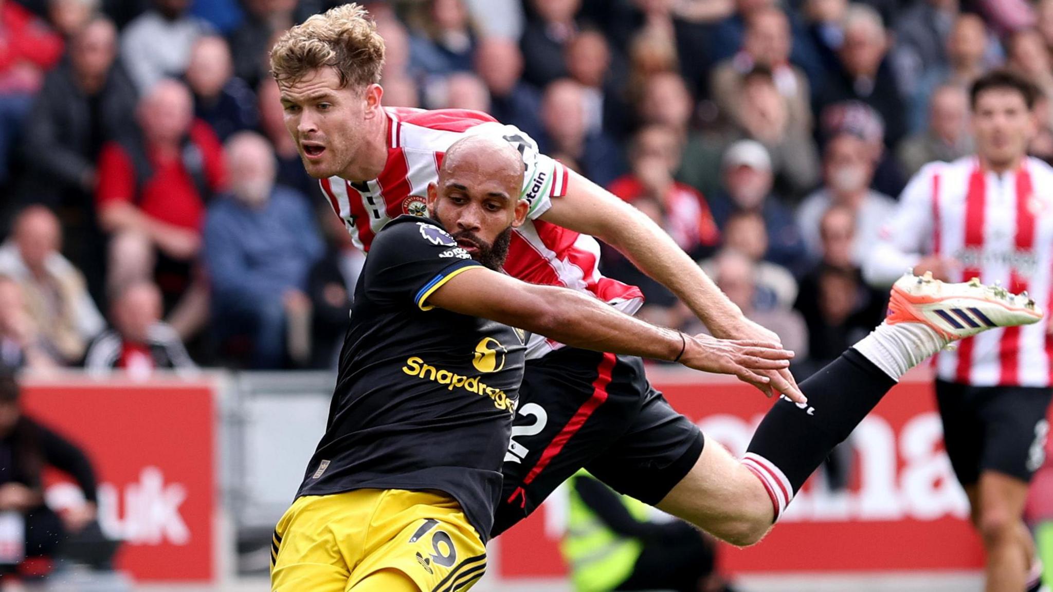 Nathan Collins of Brentford fouls Bryan Mbeumo of Manchester United