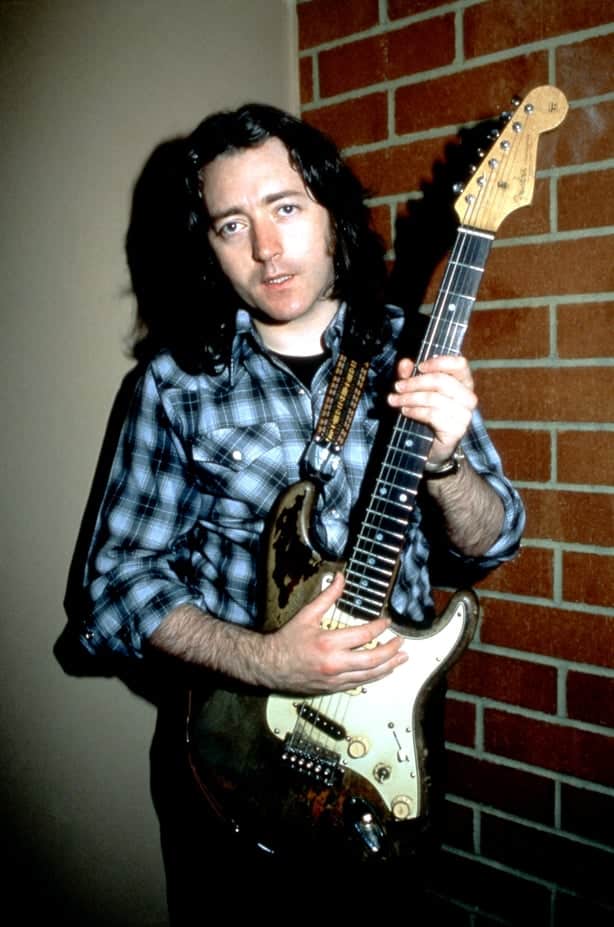 Irish blues and rock guitarist, singer, songwriter, and producer, Rory Gallagher (1948-1995), poses for a portrait with his guitar on September 25, 1982 at the Old Waldorf in San Francisco, California.
